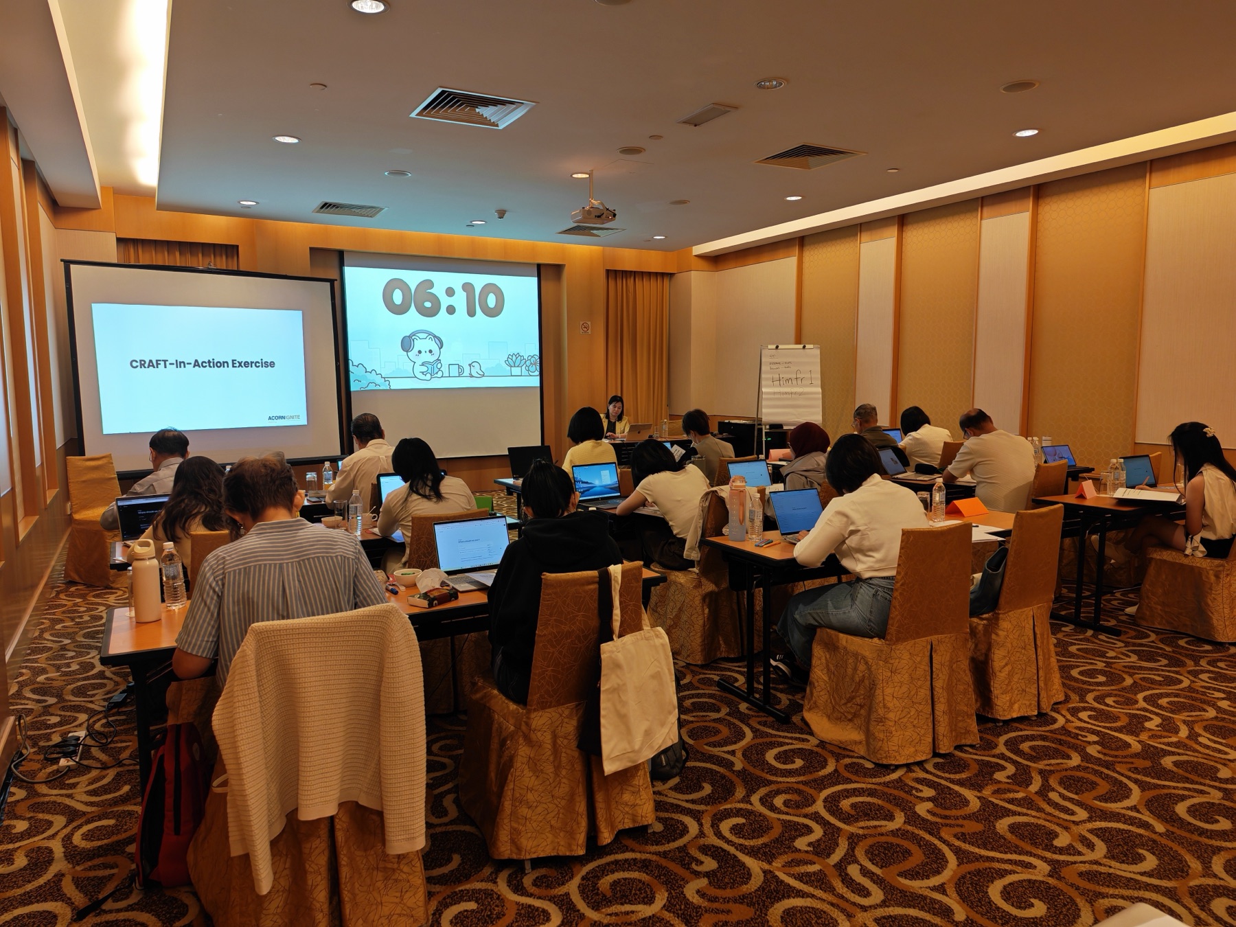 Participants using laptops during a practical AI productivity workshop